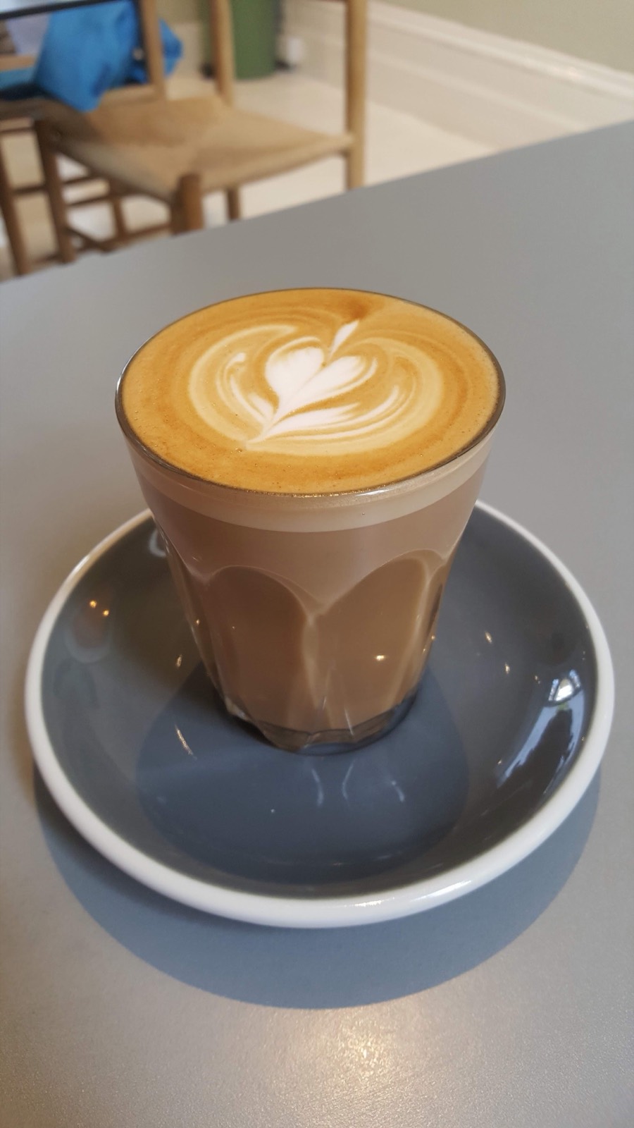 A latte served in a glass at HJEM